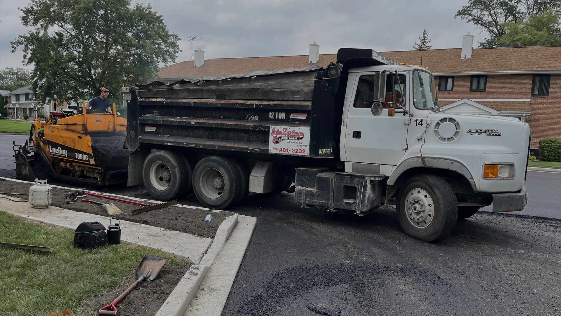 John Zarlengo Asphalt Paving crew reloading paving machine