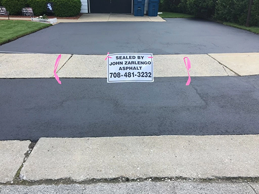 Residential driveway asphalt sealcoating in Homewood, Illinois by John Zarlengo Asphalt Paving